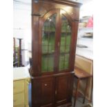 A George III corner cabinet, stepped, moulded cornice, twin glazed doors, above fielded panels