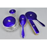 An early 20th century silver and enamel mounted matched dressing table set, comprising a hand