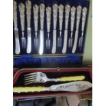 White metal and silverware to include dessert knives and forks, cased, and a silver fish server