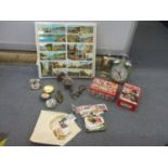 A mixed lot to include postcards, stamps, an alarm clock, tins and other items Location: 2:5