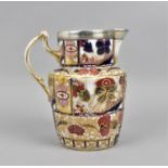 A Victorian ironstone ceramic jug, with white metal mounted rim, designed with painted florals and