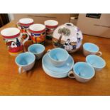 A set of six Poole Pottery coffee cups and saucers, together with a painted pottery vase of globular
