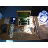 A quantity of costume jewellery to include dress watches, beaded necklaces, brooches and rings, in a
