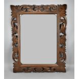 A turn of the century Continental carved oak cushion mirror, circa 1900, possibly Flemish, of