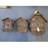 A group of three wooden cased cuckoo clocks Location: LAM