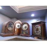 Two early 20th century Bulle patent mantle clocks, one in a light oak case with arched inlaid walnut