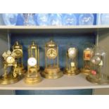 A selection of anniversary and mantle clocks, some with glass or plastic domes, to include a Tiffany