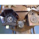 Two wooden cased cuckoo wall clocks and a cuckoo clock movement A/F