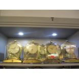 Eight 20th century Schatz mantle clocks in glass cased with fleur de lis emblem to the stand A/F