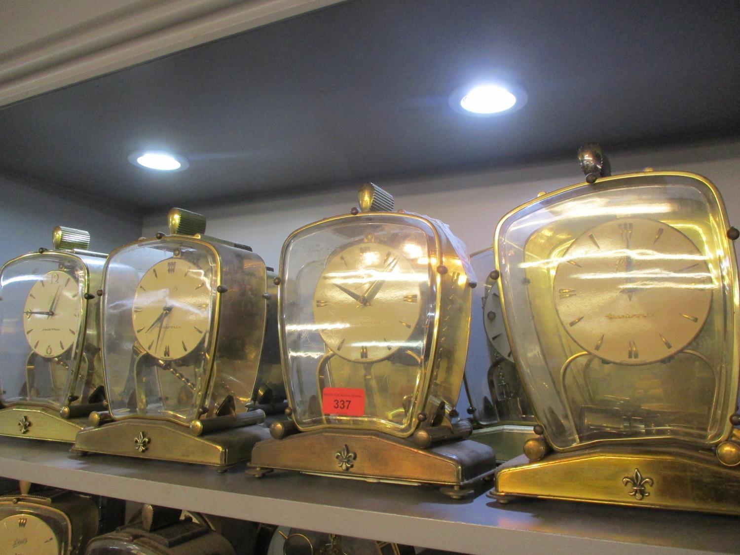 Eight 20th century Schatz mantle clocks in glass cased with fleur de lis emblem to the stand A/F - Image 2 of 2