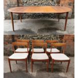 A 1960s Danish teak extending table and chairs by Skovmand & Andersen, the circular table with two