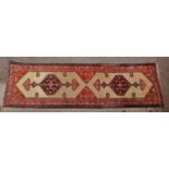 A long hand knotted Persian Sarab hallway runner, designed with ivory field sections cantered with