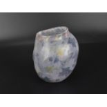 A small glass vase by Liz Lowe, with abstract decoration on a semi translucent lilac ground,