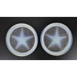 A pair of Sabino style opalescent glass coasters, of circular form with central starfish pattern,