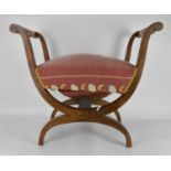 A 19th century Biedermeier upholstered window seat or curule stool, with later upholstery,