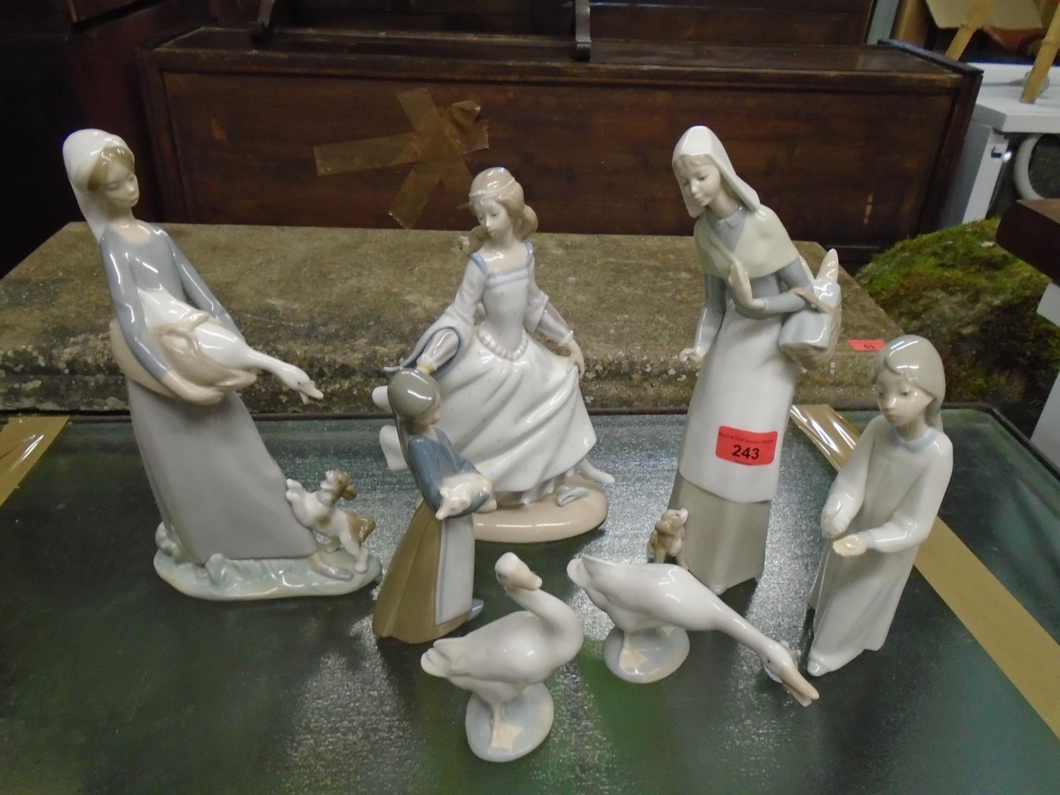 A group of Lladro figurines and animal models to include a woman carrying a basket of baguettes with