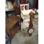 A cream painted wooden child's high chair with detachable tray, a two tier trolley, and a mercury-