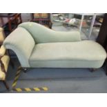 A Victorian chaise longue with velour upholstery, raised on turned legs and castors 78cm h x 178cm w