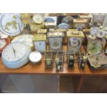 A quantity of vintage mantle, carriage and wall clocks, together with a brass cased ship's gauge