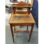 An Edwardian mahogany bonheur du jour, with bevelled mirror back, string inlay and tooled leather