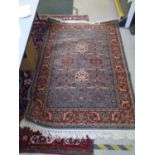 Ikaros machine woven woollen rug decorated with a floral pattern on a light blue and terracotta