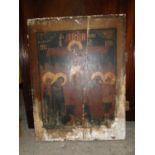 A 19th century Icon painted on a wooden panel depicting the Crucifixion with Saints either side of