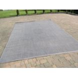 A large dark grey rug 400cm x 300cm having a grey edge, used (Condition: slight oval darkening to