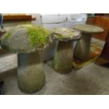 A group of three weathered garden stone and concrete staddle stones, the tallest 77cm h