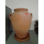 A terracotta twin handled garden jar with stand