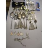 A set of eight silver Miniature Rifle Club teaspoons, a silver rifle badge and other badges,