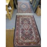 Two Persian blue ground rugs with cream coloured tassels