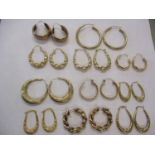 Six pairs of 9ct gold hoop earrings stamped 375, 13.8g, together with five pairs of yellow metal