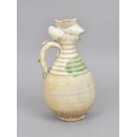 A Chinese Qingbai glazed pottery ewer of ovoid shape with phoenix head and turned detail to the
