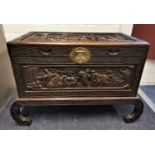 An early 20th century Chinese camphor chest, with carved figural scenes to the top and all sides,