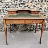 An Edwardian mahogany and strung writing desk, with pierced part gallery top above a single drawer