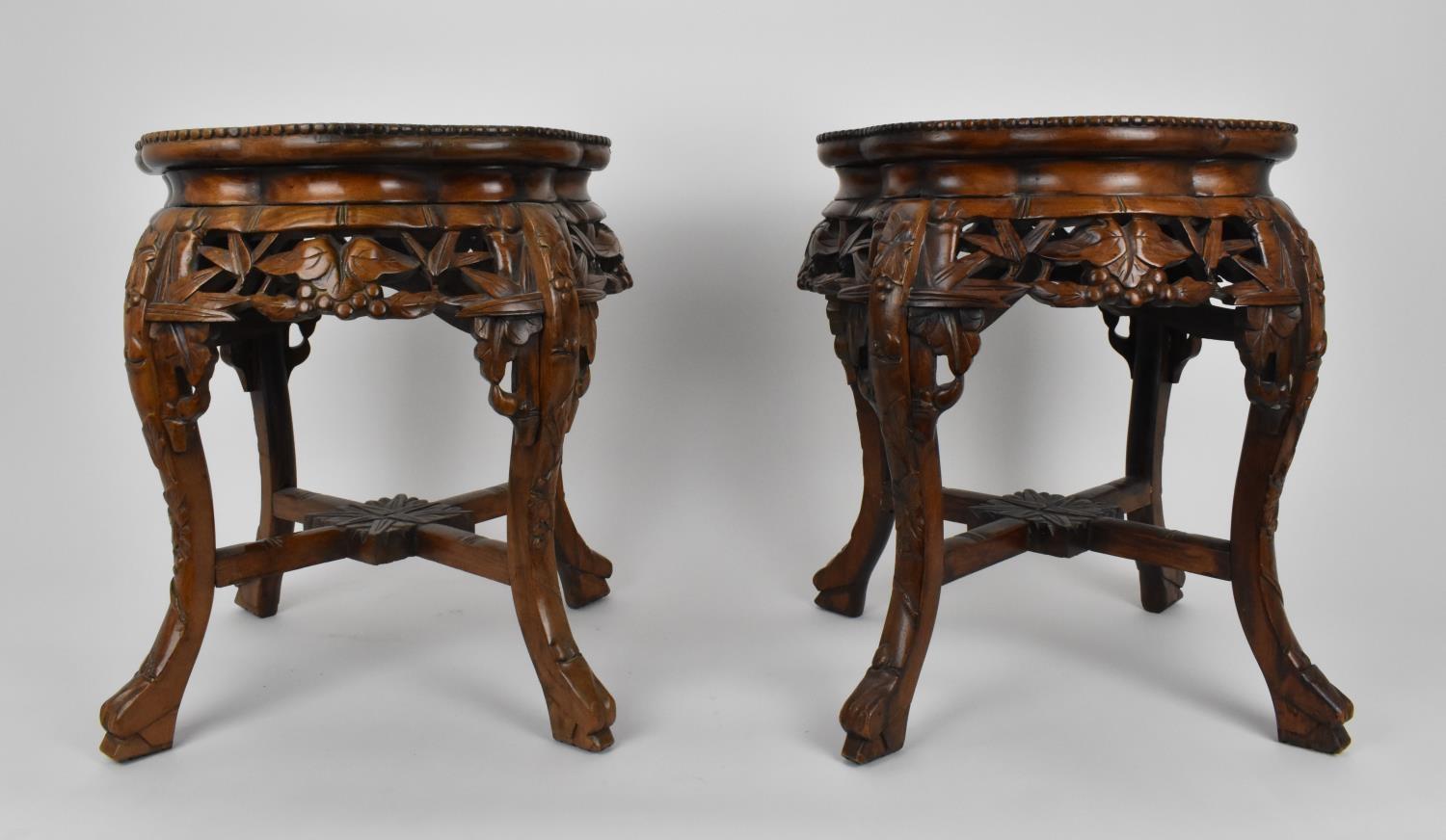 A pair of Chinese carved hardwood and marble jardiniere stands, with beaded rim and pierced