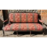 A Victorian upholstered carved walnut sofa, the centre of the back frame with carved scroll