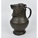 A 19th century or earlier Indo-Persian embossed copper lidded ewer, with foliate patterns