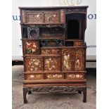 A Japanese Meiji period Shibayama inlaid and lacquer display cabinet, with finely carved ivory,