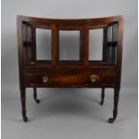 A Regency mahogany canterbury, with four divisions above a single frieze drawer with brass