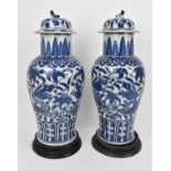 A pair of Qing dynasty blue and white porcelain lidded vases, 19th century, of baluster shape with