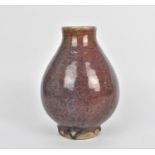 A Chinese flambe glazed vase, 18th century or earlier, with bulbous body on a short circular base,