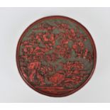 A Chinese Qing dynasty carved cinnabar lacquer box, of cylindrical form, the lid with intricately