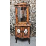 A French Belle Epoque vitrine cabinet, of serpentine form with glazed vitrine standing atop a