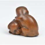 A Japanese carved wood netsuke, 19th century, modelled as two puppies, unsigned, 3 cm high x 3.5