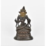 A Sino-Tibetan bronzed copper alloy model of Tara Bodhisattva, sat in a lotus position holding a