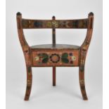 A Norwegian folk art painted and stained wooden chair with horse shoe back, on three legs,