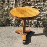 A William IV rosewood side table, with circular top above a central faceted column on a triform base