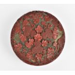 A Chinese Qing dynasty carved cinnabar lacquer box, of circular form, with intricately detailed