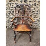 A 19th century ash windsor chair with comb back, pierced splat, supported on turned legs with